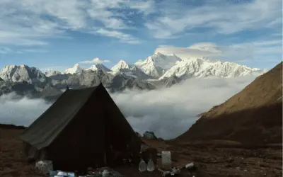 A tent perched on a mountain ridge, surrounded by majestic Himalayan peaks. Embark on the Goechala Trek for an awe-inspiring adventure through the heart of the Himalayas.